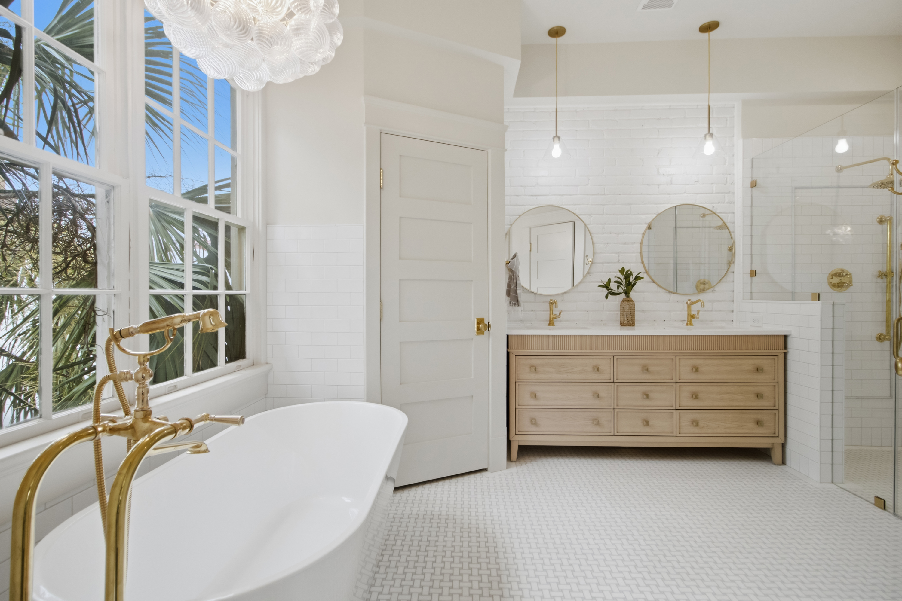 Primary bath with marble and a freestanding tub